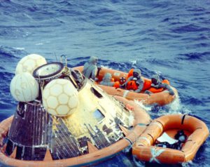 Clancy Hatleberg (vlevo; jako jediný nemá nafukovací vestu) a posádka Apolla 11 ve člunu po přistání